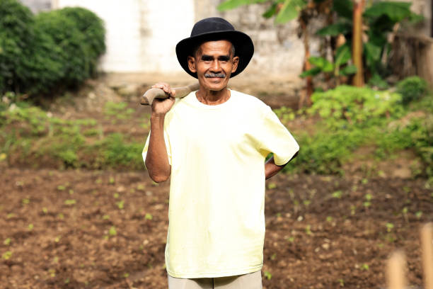 Retired Old Asian Man on Small Farm Besides His Home