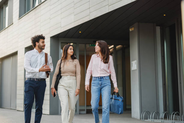 istock Diverse Colleagues Walking and Talking Outside Office Building 2191983479