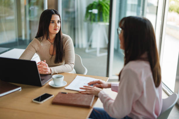 istock Businesswomen in Discussion at Office Table 2191983481