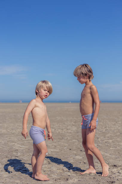 Brothers Bonding on the Beach Under a Clear Sky in Knokke-Heist, Flanders, Belgium