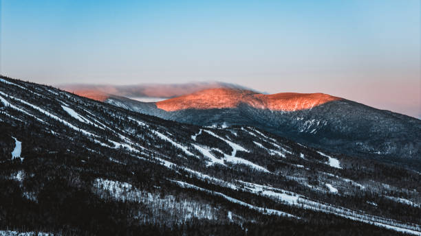 Alpenglow on Crocker Mountain, Maine in winter. in Carrabassett Valley, Maine, United States
