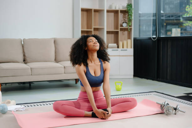 istock African Woman Doing Yoga and Watching Online Tutorials on Laptop, Training 2191991041