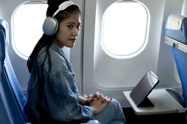 istock Young woman wearing headphones looking at tablet or computer 2191999472