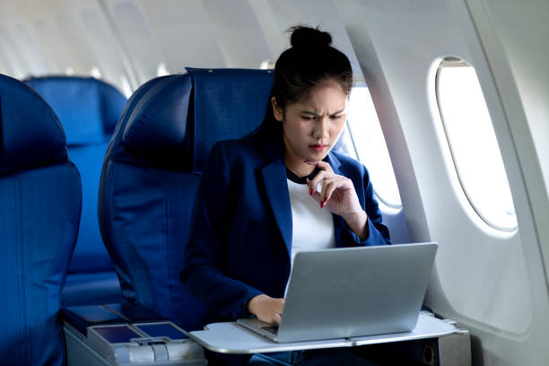 istock young woman using a laptop computer while traveling comfortably in an airplane 2192000029