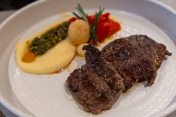 istock Juicy grilled beef served with creamy mashed potatoes, roasted tomatoes, and garnished with herbs. 2192002241