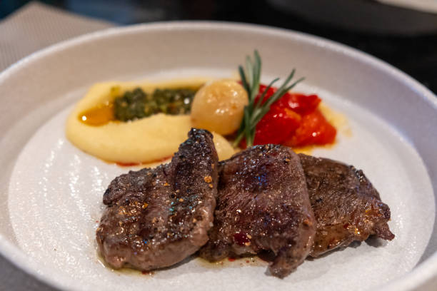 istock Juicy grilled beef served with creamy mashed potatoes, roasted tomatoes, and garnished with herbs. 2192002253