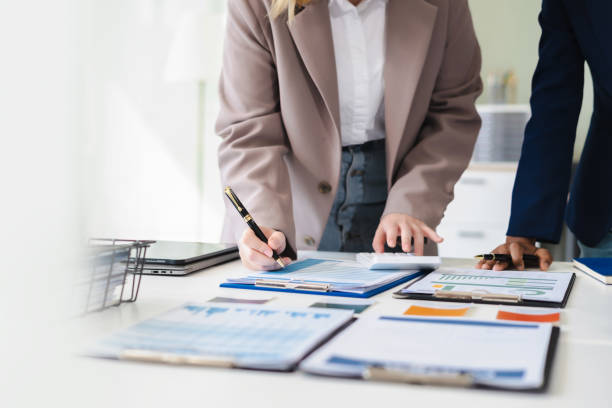istock Diverse professionals collaborate on project analysis with financial graphs. Strategic teamwork and insights drive company growth and success. 2192003640