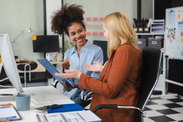 istock Diverse professionals collaborate on project analysis with financial graphs. Strategic teamwork and insights drive company growth and success. 2192003656