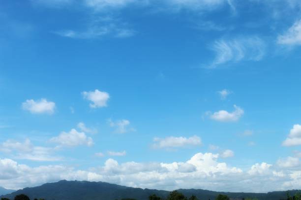 Focus on clouds. The sky was bright blue with pure white clouds like soft cotton.  Full frame shot. Clear sky blue sky background