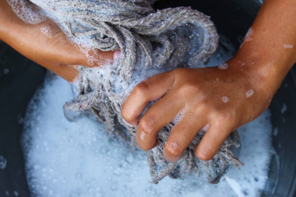 istock hands wringing out a mop full of soap suds 2192004384