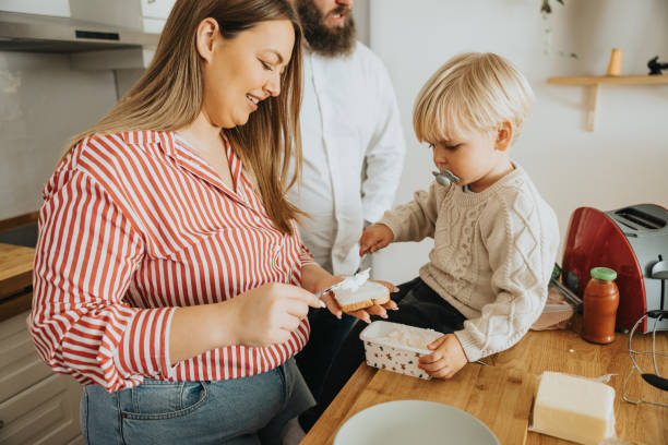 istock Young father and mother with little son preparing breakfast before going to work 2192004425
