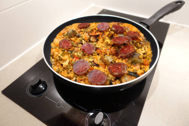 Seafood paella with chorizo ​​and vegetables being cooked