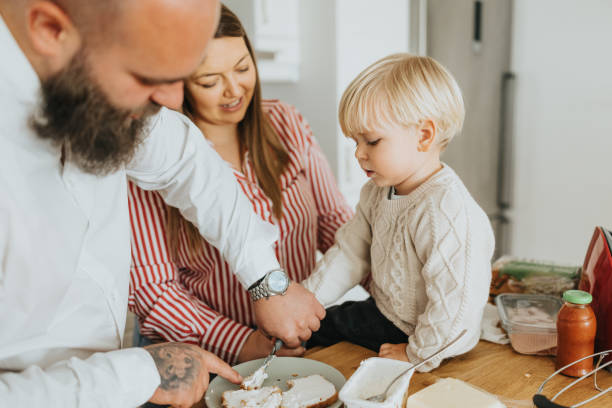 istock Young father and mother with little son preparing breakfast before going to work 2192005261