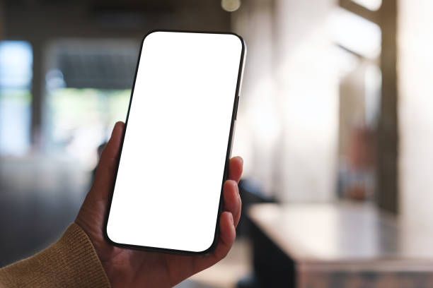 istock Mockup image of a woman holding and using mobile phone with blank desktop in cafe 2192007015