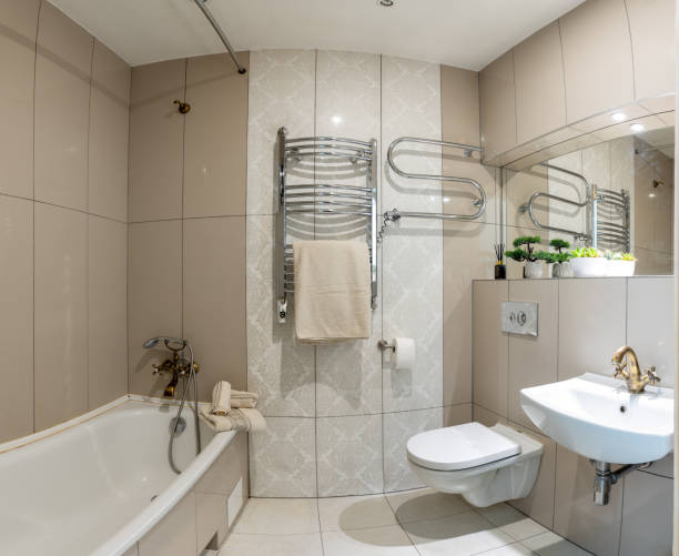 Bright Elegant Retro Classic Style Home Bathroom Interior Design With White Sink. Mirror and Faucet. LED Lights. Shower Area, Heater, Tile Floor and Walls. Wide Angle
