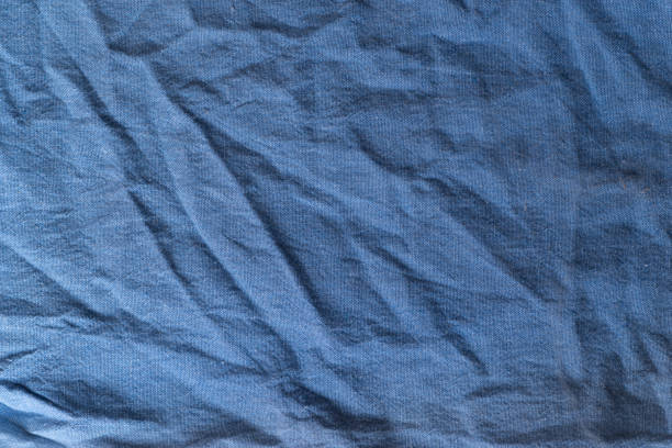 Blue synthetic fabric swatch showing tightly woven threads and fine texture