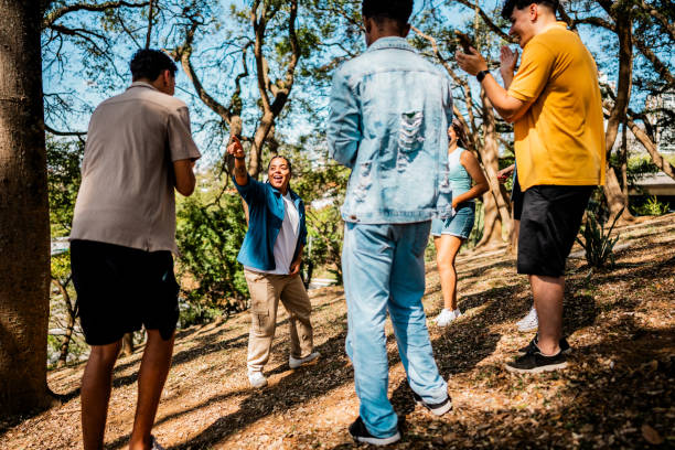 Young friends dancing in the park