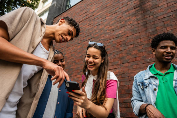 istock Young friends using the mobile phone in the street 2192012595
