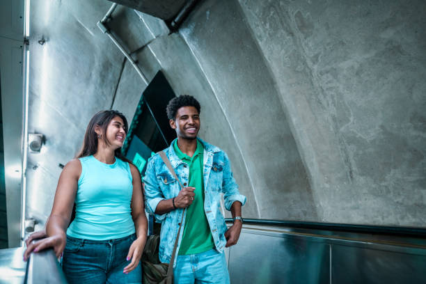 istock Young couple talking on the escalator at a subway station 2192012687