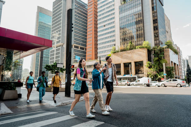 istock Young friends talking while walking in the street 2192012719
