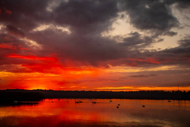 istock A stunning and breathtaking sunset casts its colors over calm water, creating beautiful reflections 2192012766