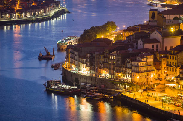 Illuminated Waterfront in Porto, Portugal at Night