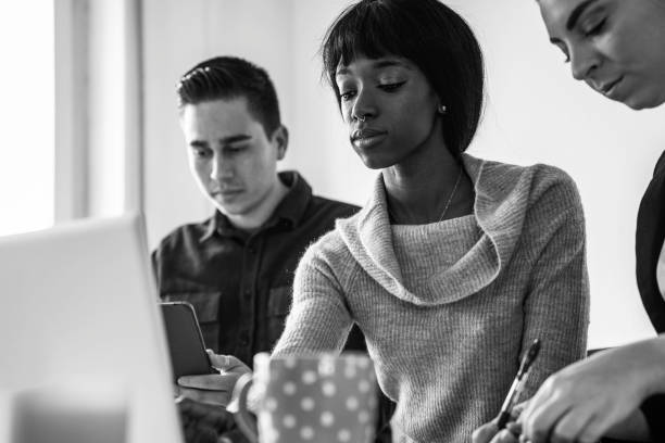 istock Multiracial business people working inside modern office - Focus on young black woman face - black and white editing 2192015593