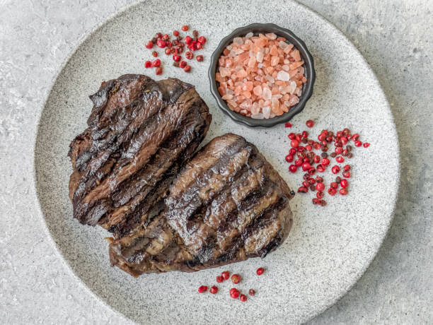 istock Grilled beef steak with salt, spices and herbs 2192015783