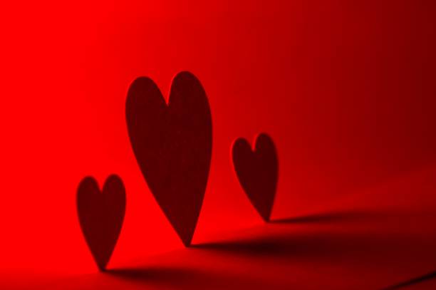 3 hearts against a glowing red background
