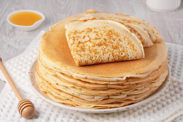 istock Stack of traditional russian pancakes blini on a white table. Homemade russian thin pancakes blini. Russian food, russian kitchen 2192018967