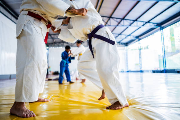 istock Low section of judo athletes fighting on a dojo 2192019091