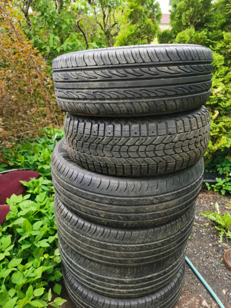 istock Stack of Used Car Tires in an Outdoor Setting 2192019326