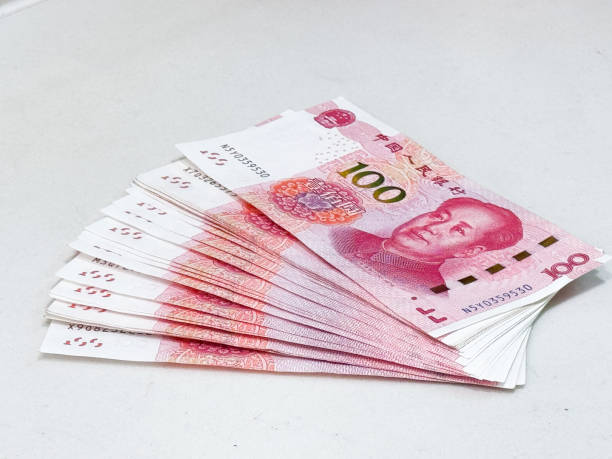 istock Stack of 100 Chinese Yuan Banknotes on a White Surface. The renminbi 2192019339