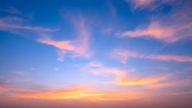 istock Dusk sky with yellow and orange clouds on horizon blue sunset sky background after sundown 2192019738
