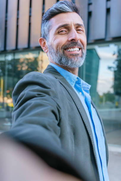 istock Confident Businessman Taking a Selfie Outdoors.Vertical 2192021534