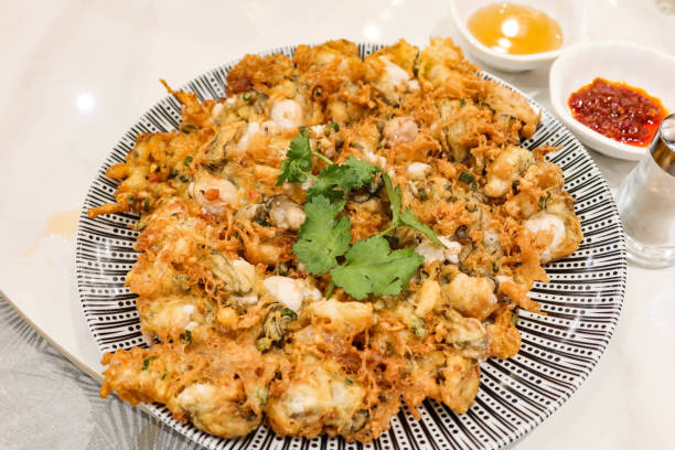 close up of Chinese Chaozhou style deep fried Oyster omelette close up of Chinese Chaozhou style deep fried Oyster omelette chaozhou guangdong stock pictures, royalty-free photos & images