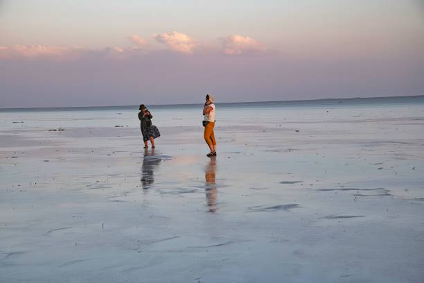 Danakil desert, Ethiopia - 12 09 2024: tourists on the wide and remote location of a Salt Lake in the Ethiopian Danakil depression