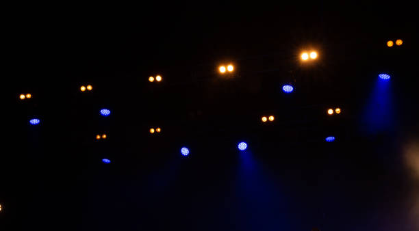 istock Spotlights and laser beams. Concert light. Stage lights. Soffits 2192034164