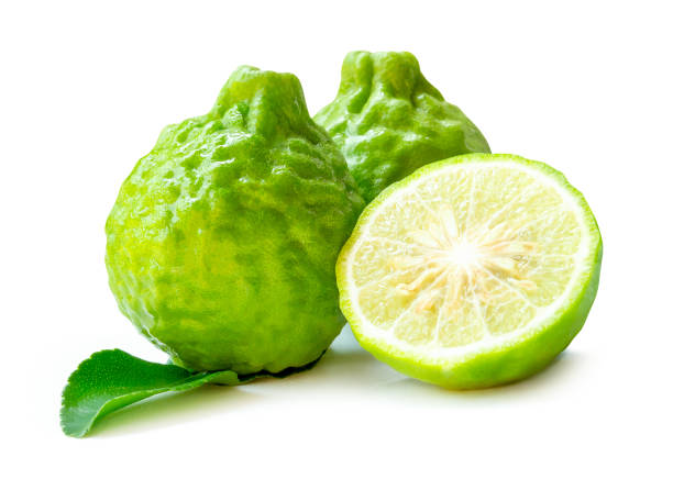 istock Front view of fresh green bergamot fruits or kaffir lime with half and green leaf in stack isolated on white background with clipping path 2192034285