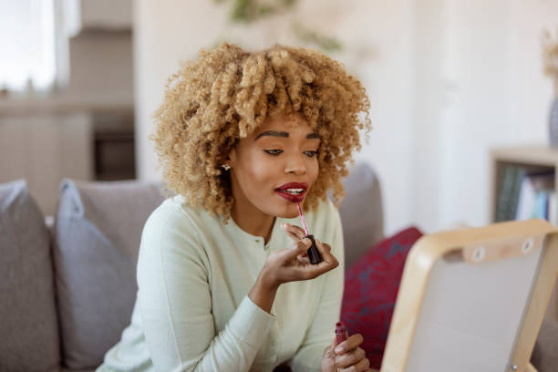 istock Black Woman Enjoying a Beauty Session with Makeup in Comfortable Home Space 2192035339