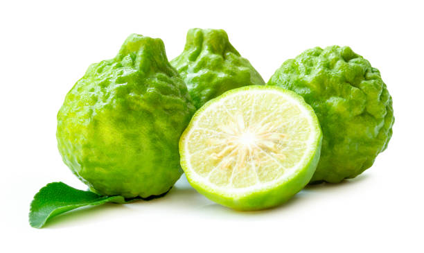 istock Three fresh green bergamot fruits or kaffir lime with half and green leaf in stack isolated on white background with clipping path 2192035392