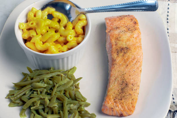 Salmon, bok choy, vegetables and lentill  in a plate.
