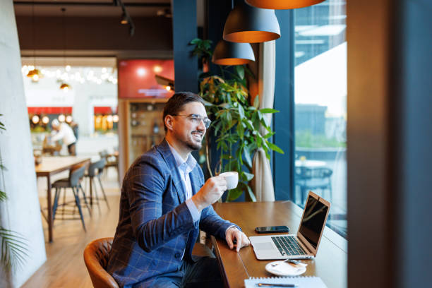istock Businessman enjoying a coffee break while working on his laptop in a cafe 2192037724
