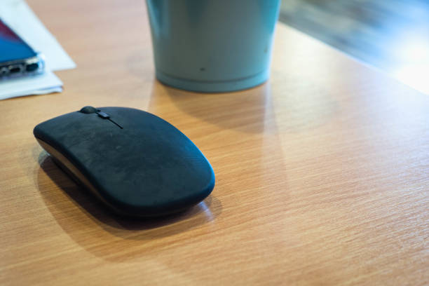 computer stylish wired mouse on a dark background. Orgonomics of the hand and wrist when working at the computer