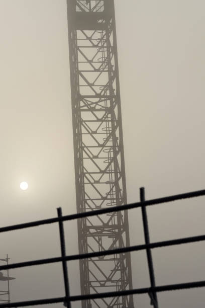 Crane on a construction site on a foggy morning