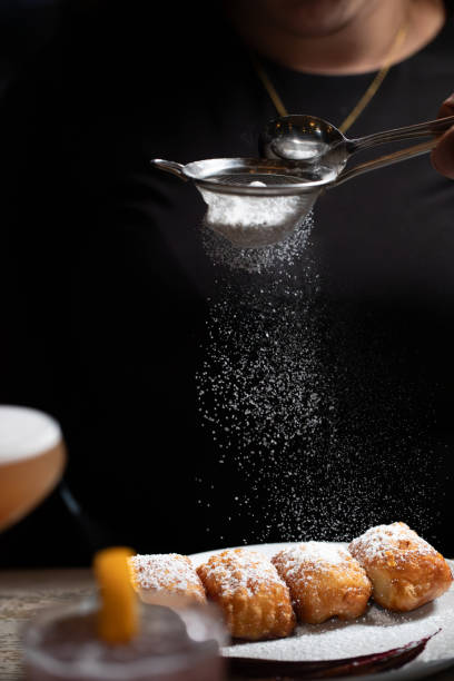 Beignetsfried pastry dough. powdered sugar. berry compote.