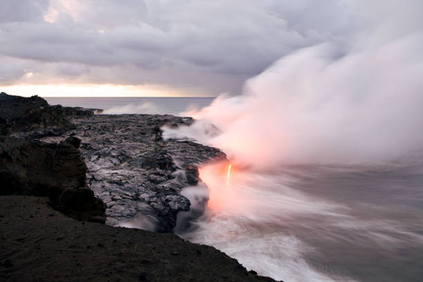 Lava flows into the ocean, creating a dramatic plume