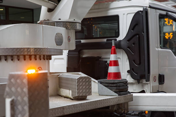 Traffic cone is placed on the platform of a truck with flashing lights, ensuring safety