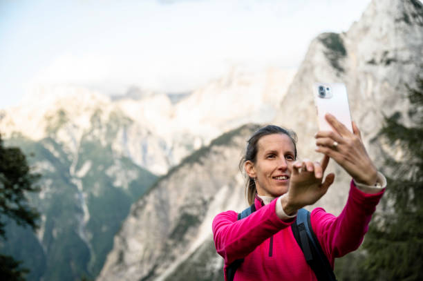 istock Female hiker taking a selfie in mountain landscape 2192044890