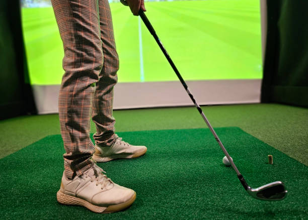 istock Golf player playing golf indoors on golf simulator closeup 2192048619